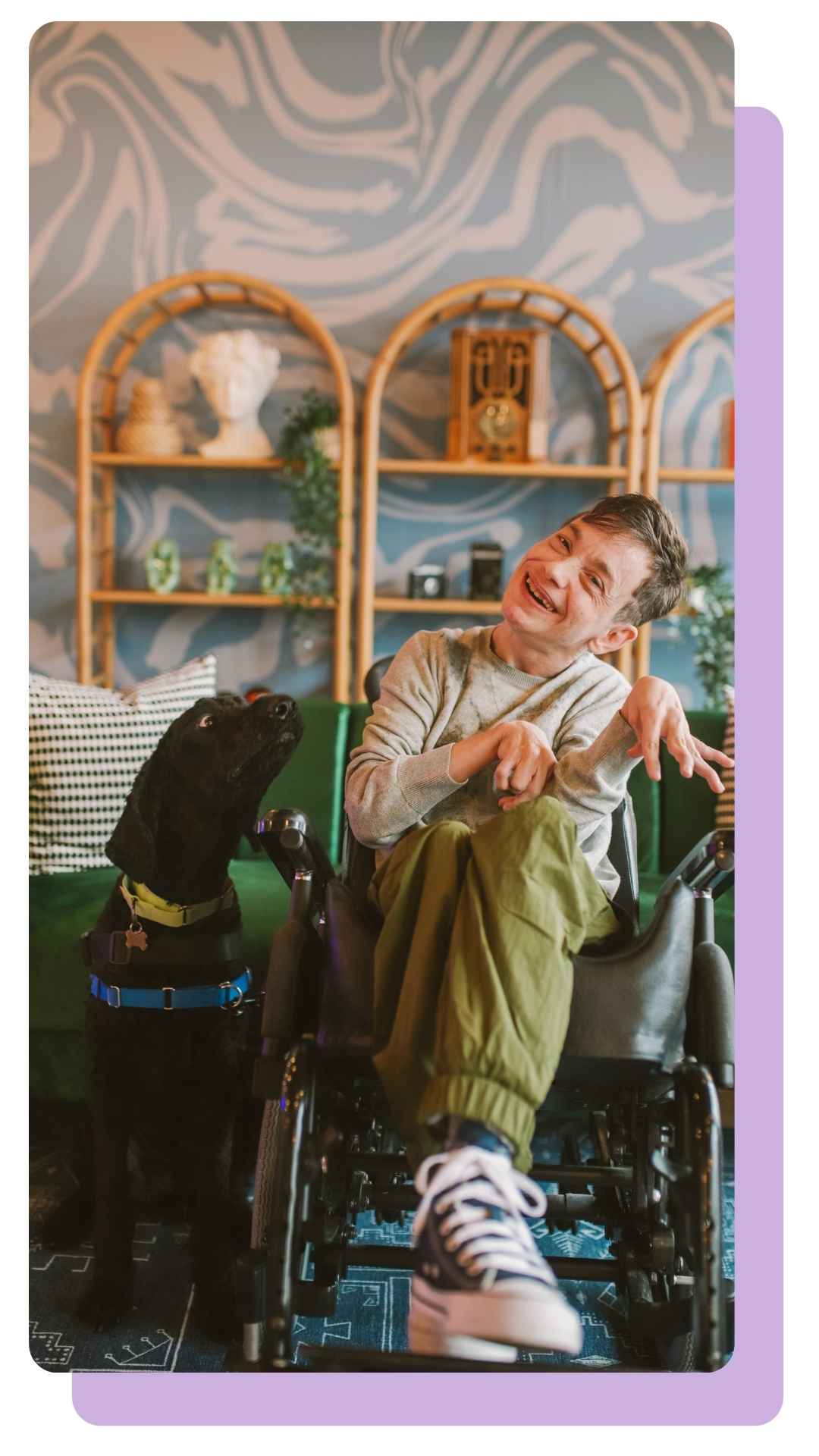 Smiling person in wheelchair with support dog – Person Centred Care by OneCall24.