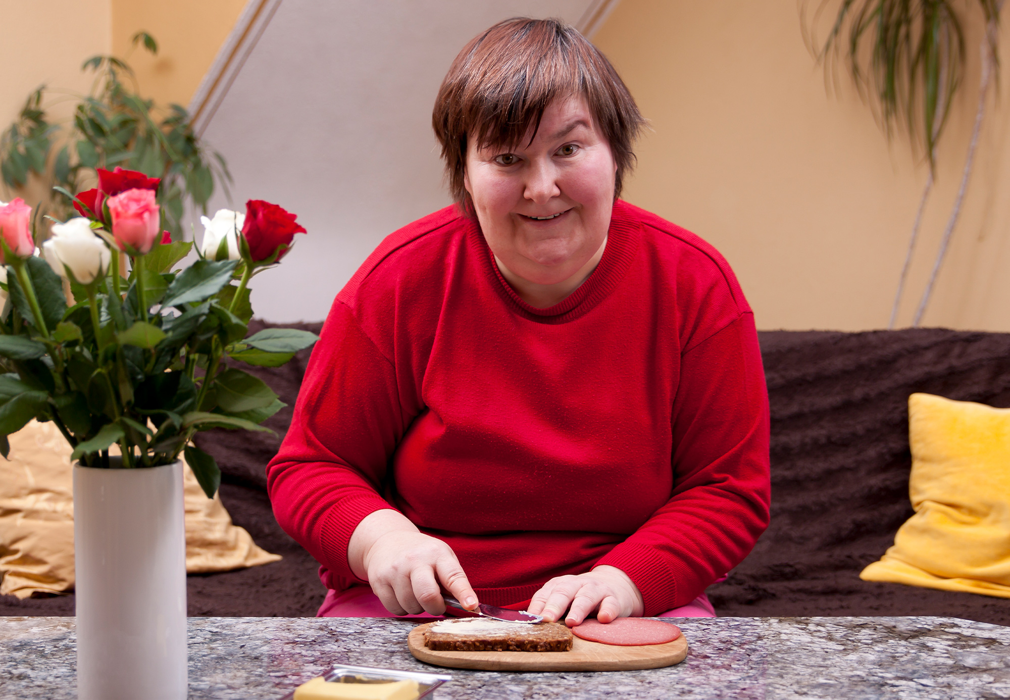 A disabled woman engaging in life skills within her accommodation